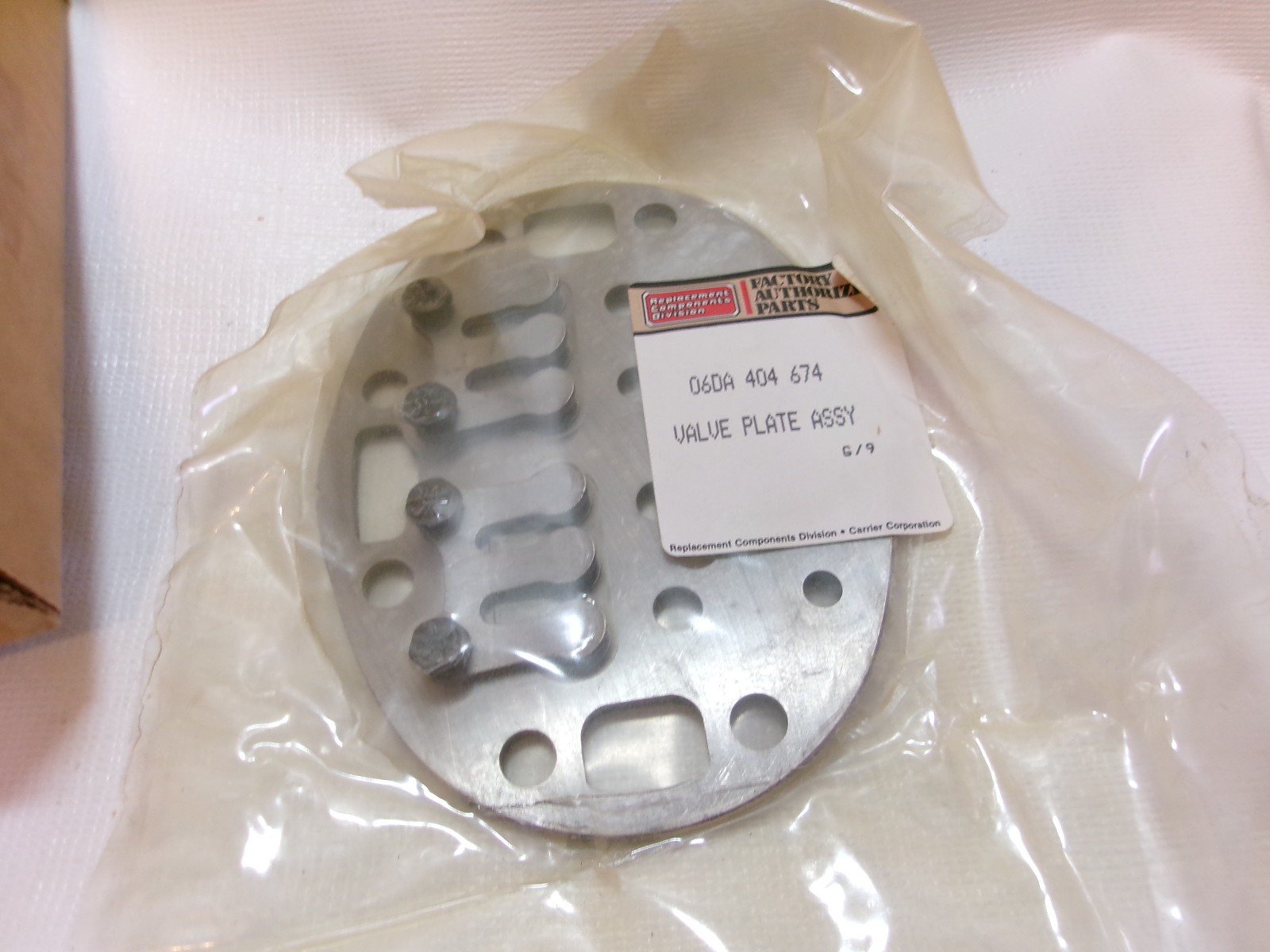 NEW in BOX CARRIER 06DA 404 674 VALVE PLATE ASSEMBLY