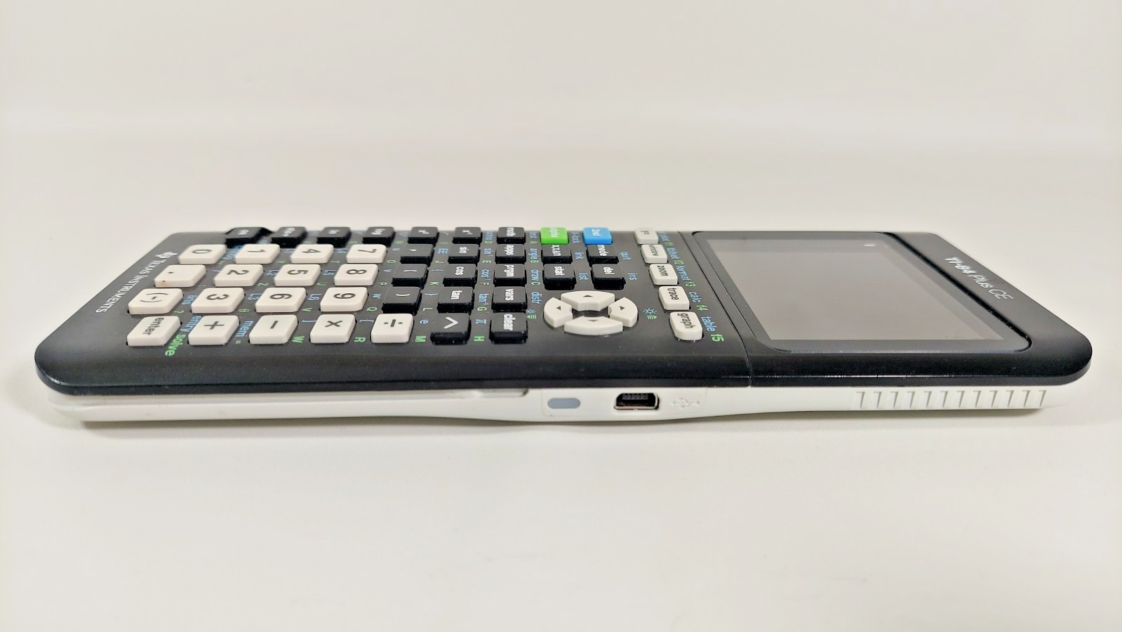 Texas Instruments Ti 84 Plus Ce Graphing Calculator with a charger cable