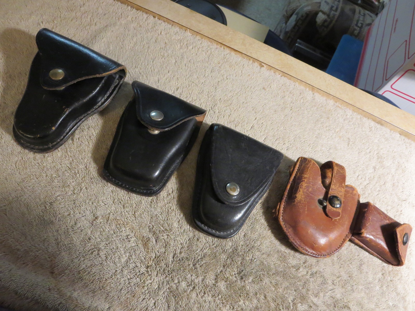 4 handcuff cases: 3 brand names in excellent cond. 1 older, modified, no name.