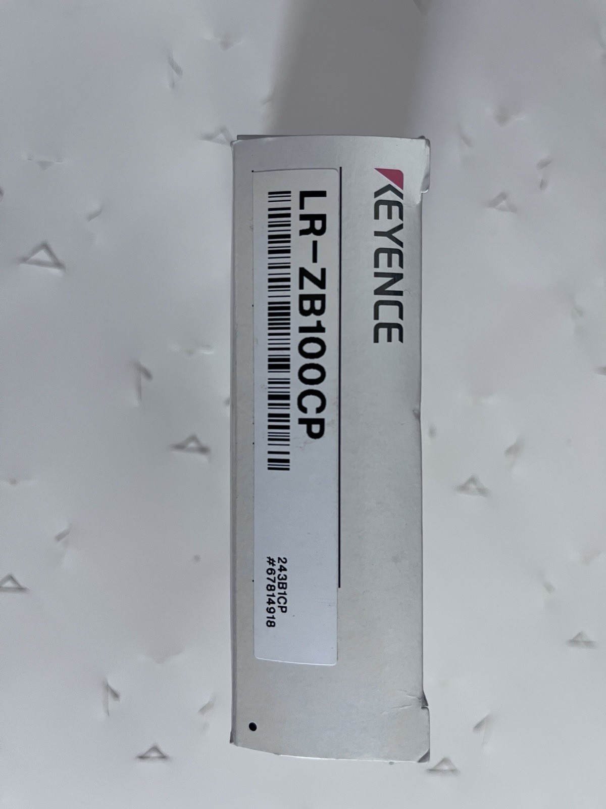 This is a Keyence LR-ZB100CP self-contained CMOS laser sensor.