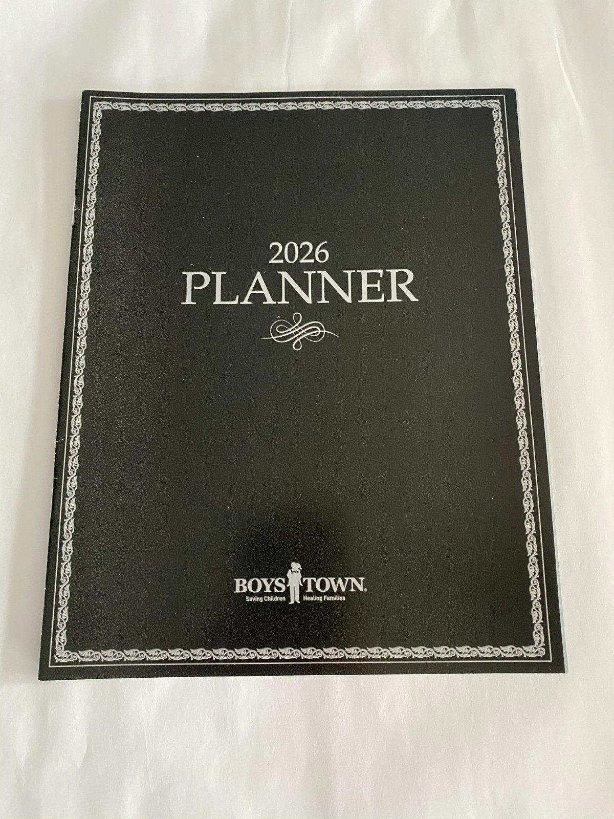 2026 PLANNER FROM BOYS TOWN – IN the BACK IT HAS 2026 & 27 MONTHS & HOLID Unused