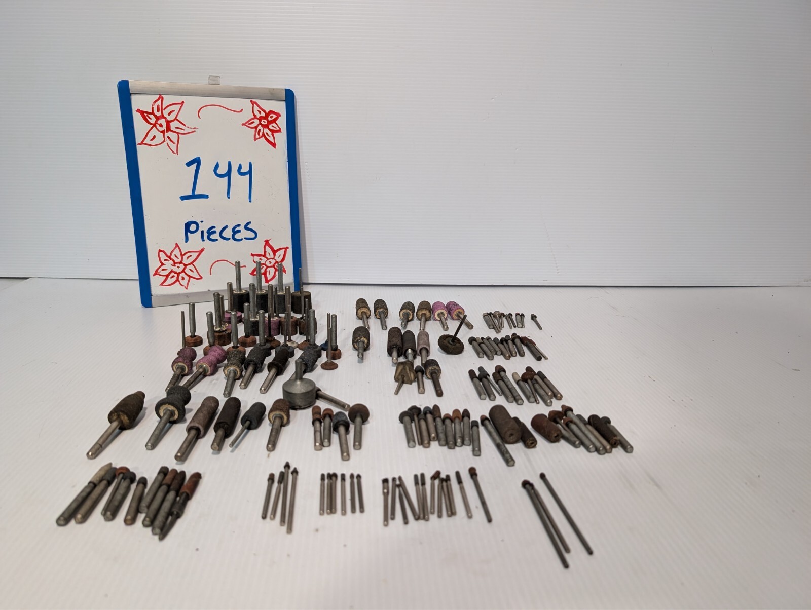 Lot of 144 mounted grinding wheels on shaft as shown, various sizes, shapes, …