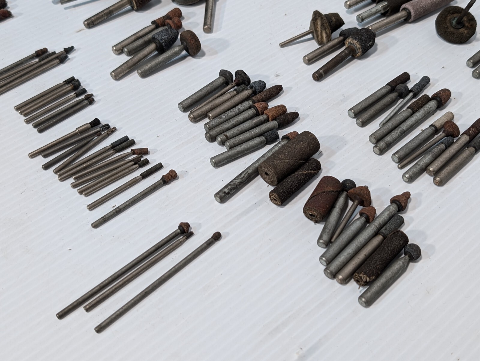 Lot of 144 mounted grinding wheels on shaft as shown, various sizes, shapes, …