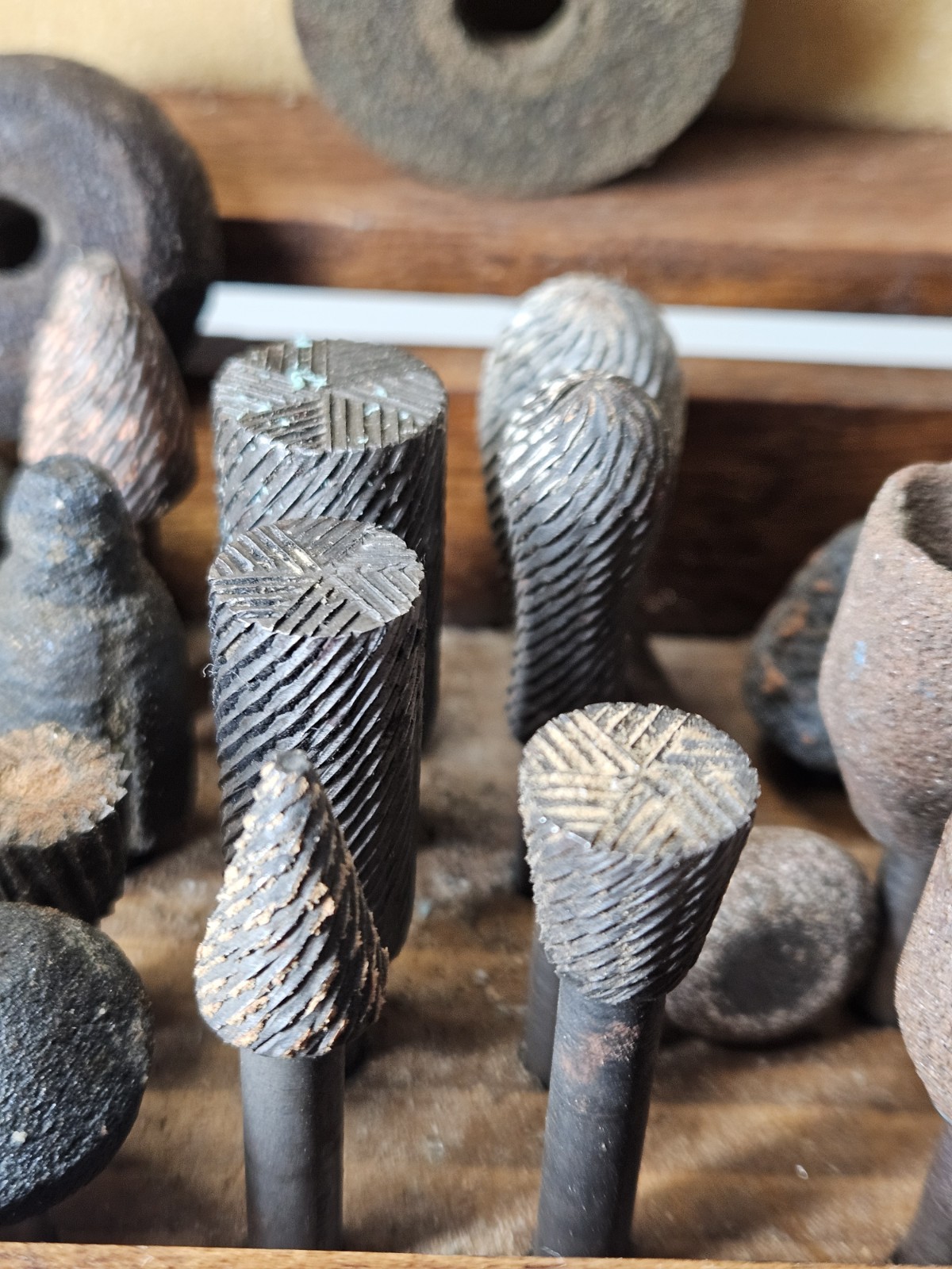 Lot of 30+ mounted grinding wheels on shaft as shown, various sizes With Case