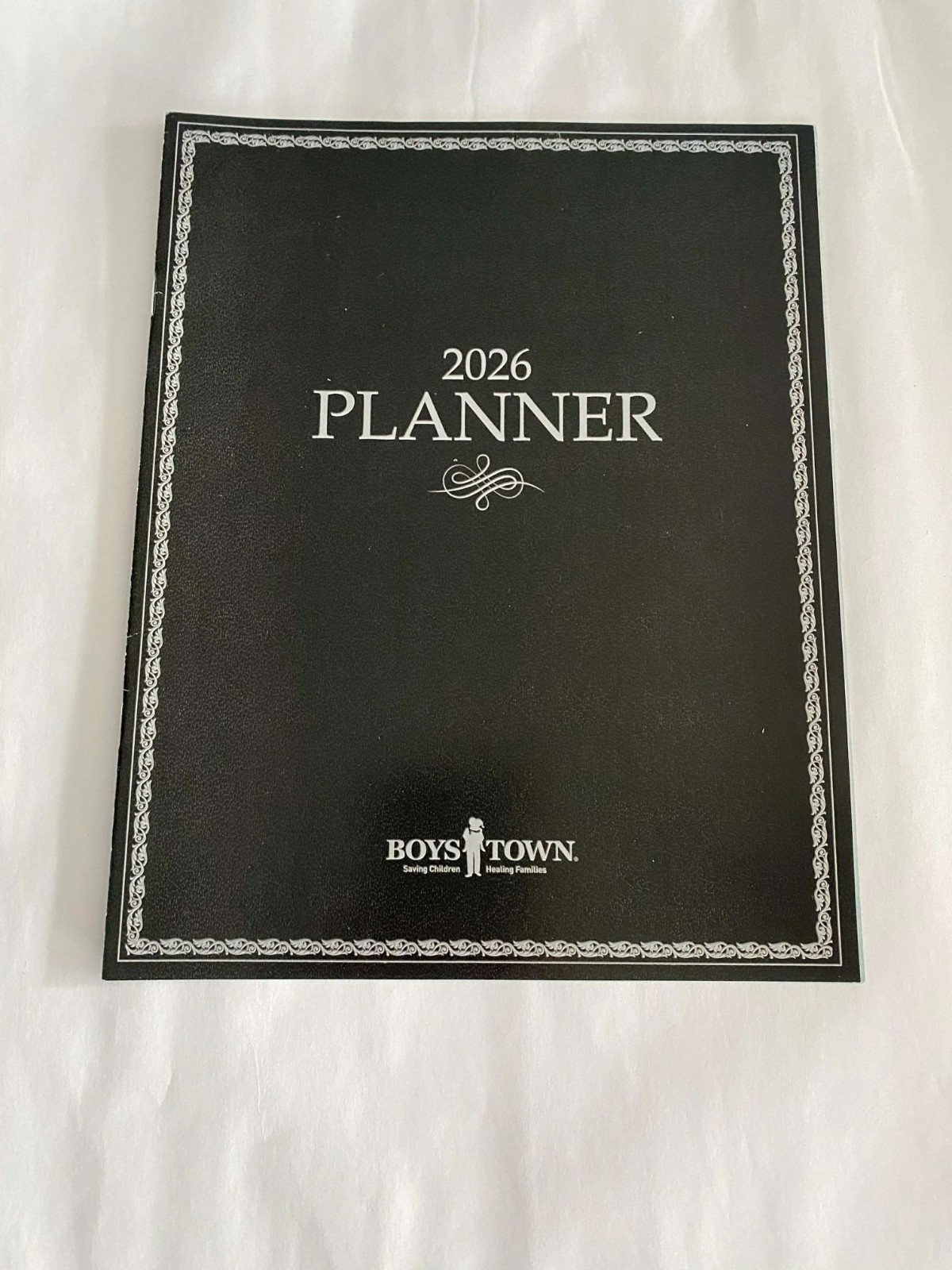 2026 PLANNER FROM BOYS TOWN – IN the BACK IT HAS 2026 & 27 MONTHS & HOLID Unused