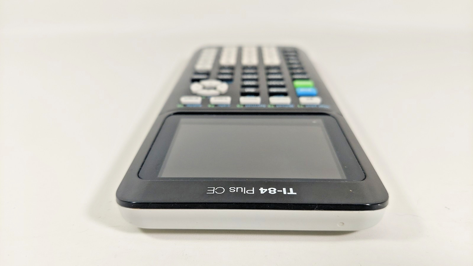 Texas Instruments Ti 84 Plus Ce Graphing Calculator with a charger cable