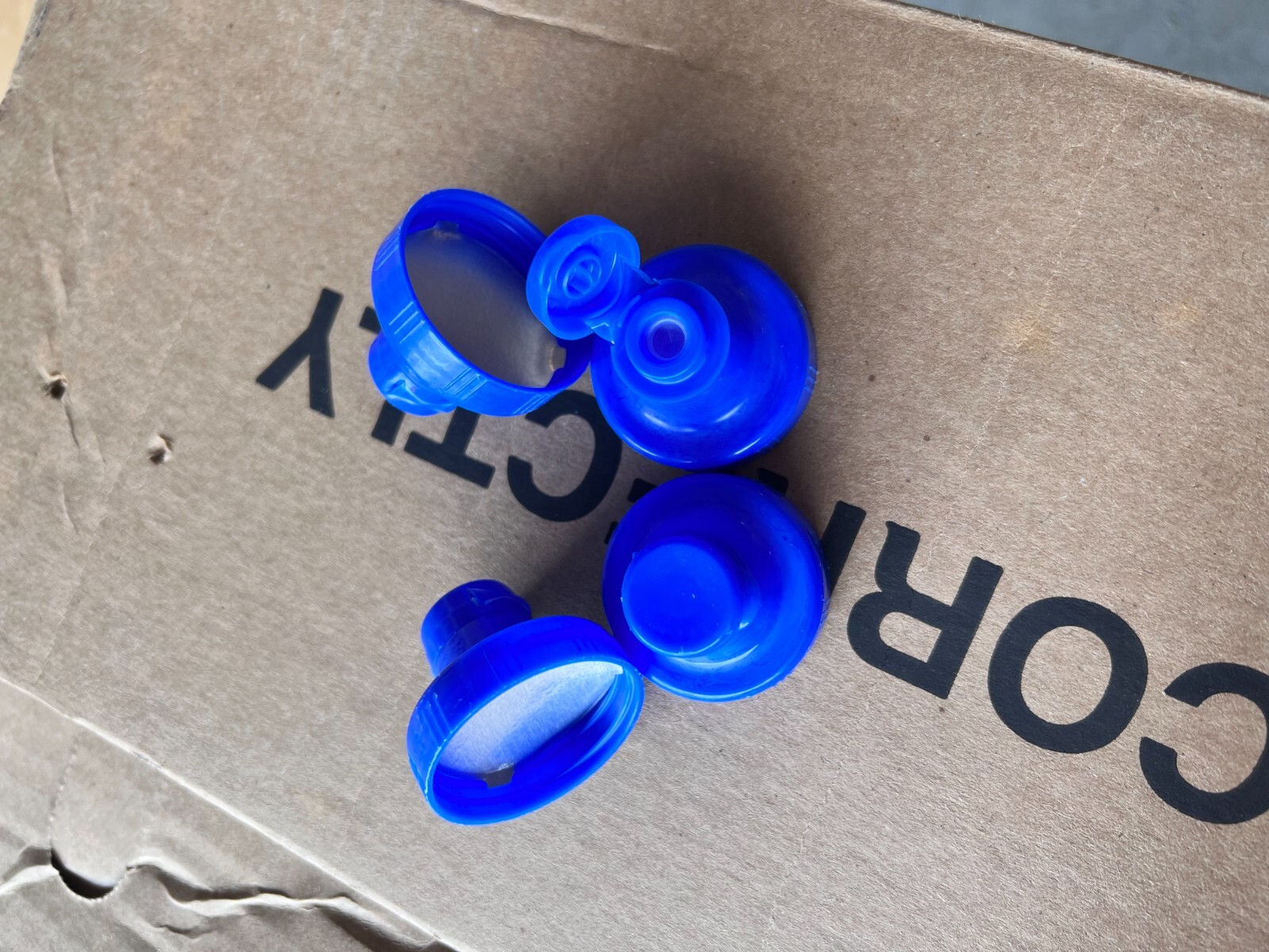 Aptar-38-400 Blue Flip Top Tab Caps with valve. Quantity 1200 per box