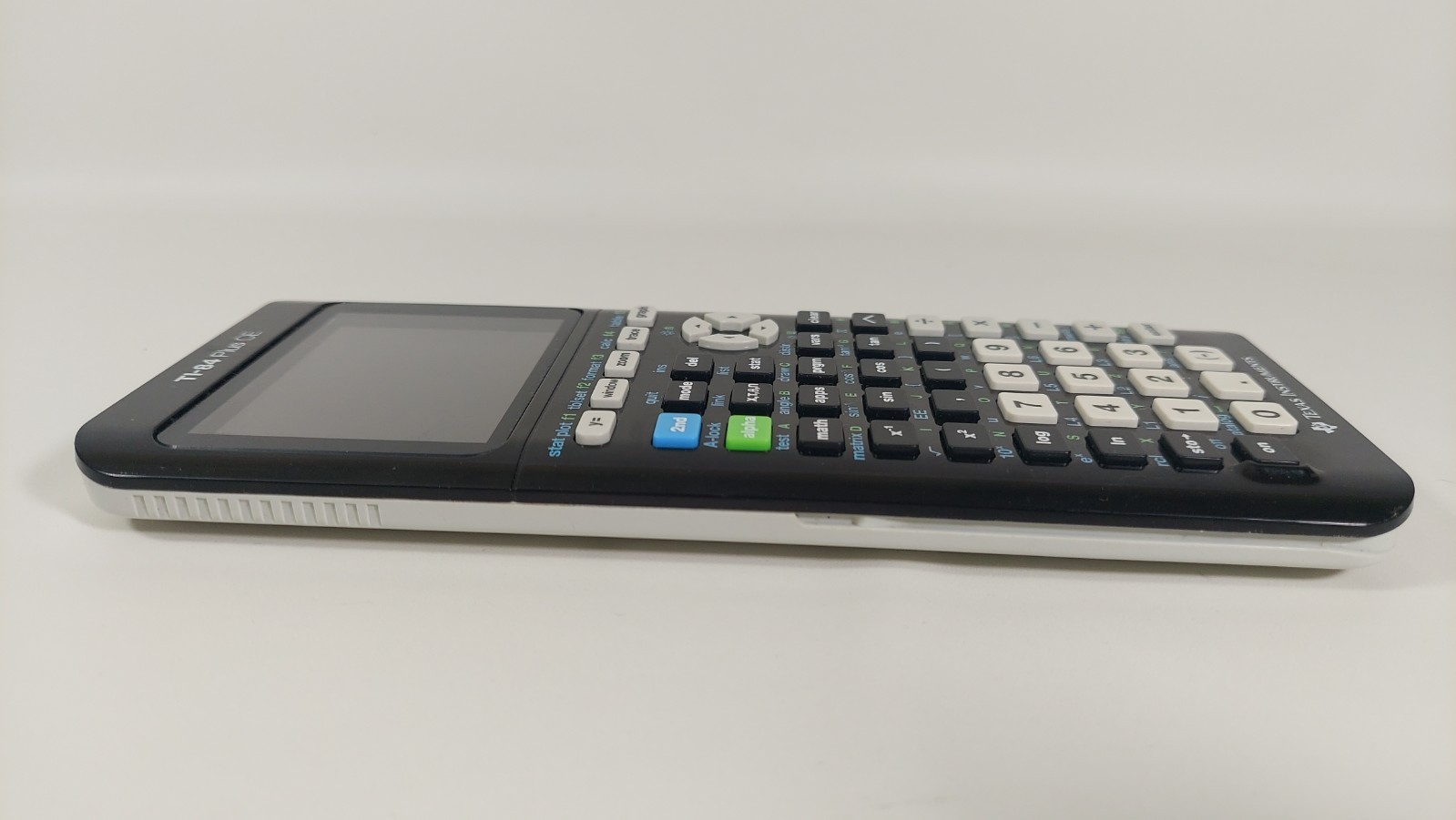 Texas Instruments Ti 84 Plus Ce Graphing Calculator with a charger cable